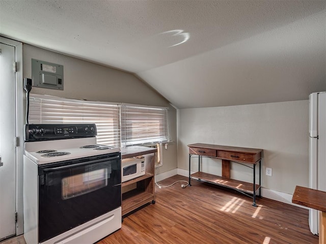 kitchen featuring wood-type flooring, lofted ceiling, a textured ceiling, and white appliances