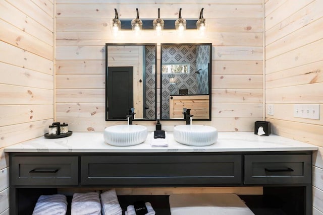 bathroom featuring vanity and wooden walls