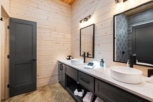 bathroom featuring vanity and wood walls