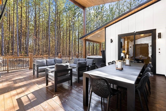 deck with a hot tub and outdoor lounge area