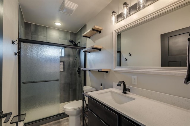 bathroom with toilet, walk in shower, and vanity