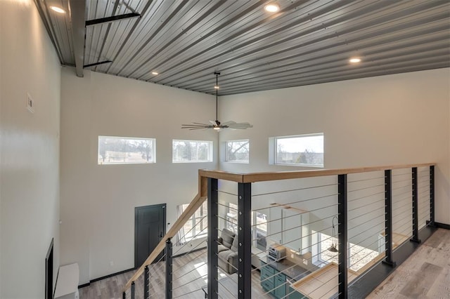 stairway featuring hardwood / wood-style flooring and ceiling fan