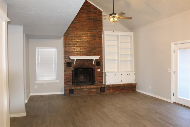 unfurnished living room with vaulted ceiling, a brick fireplace, dark hardwood / wood-style floors, and ceiling fan