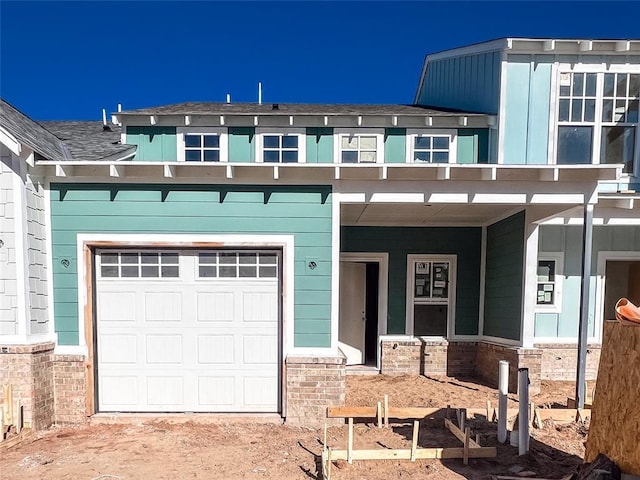 view of front of house featuring a garage and a porch