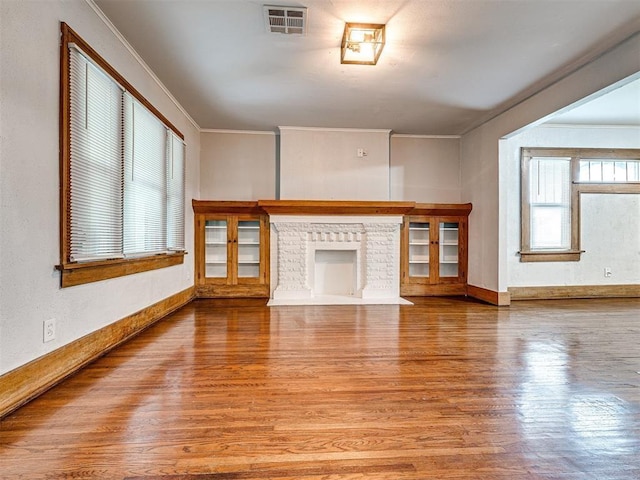 unfurnished living room with ornamental molding, light hardwood / wood-style floors, and a fireplace