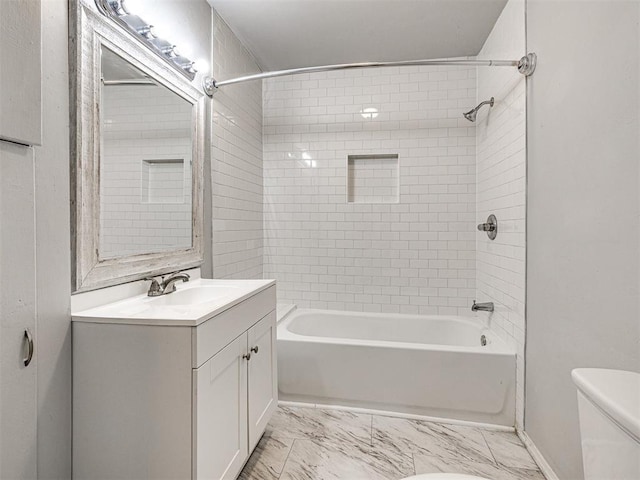 full bathroom featuring vanity, toilet, and tiled shower / bath