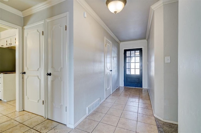 entrance foyer featuring light tile patterned floors and crown molding