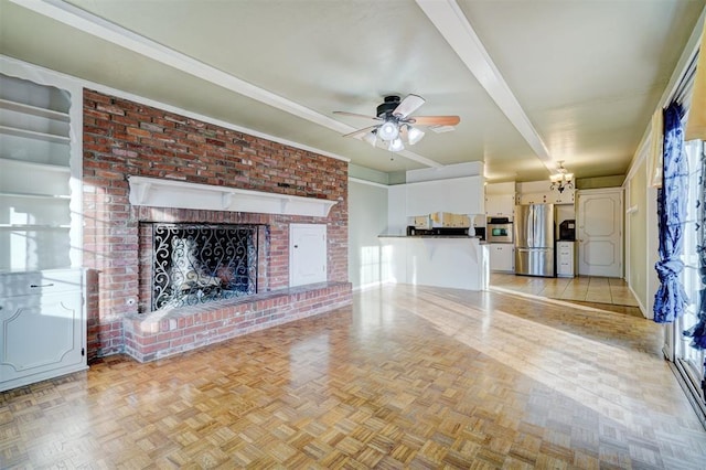 unfurnished living room with ceiling fan, a fireplace, beam ceiling, and light parquet floors