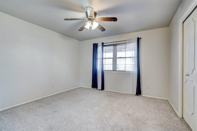 unfurnished room featuring light carpet and ceiling fan