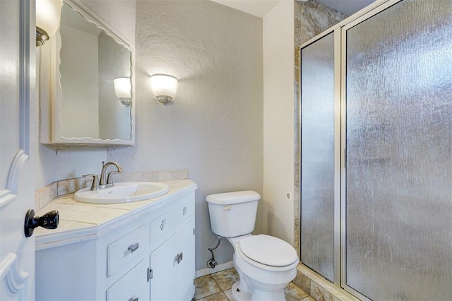 bathroom featuring an enclosed shower, vanity, tile patterned floors, and toilet