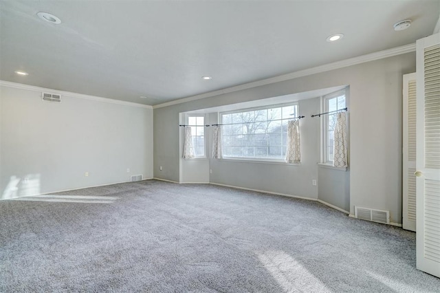 carpeted empty room featuring crown molding