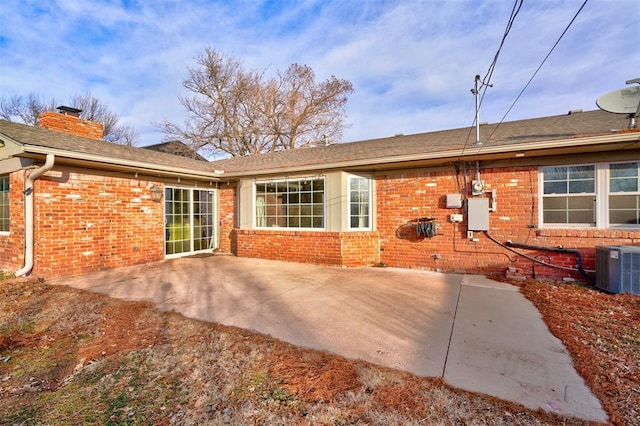 rear view of house featuring central AC and a patio