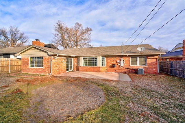 rear view of house with a patio and central AC