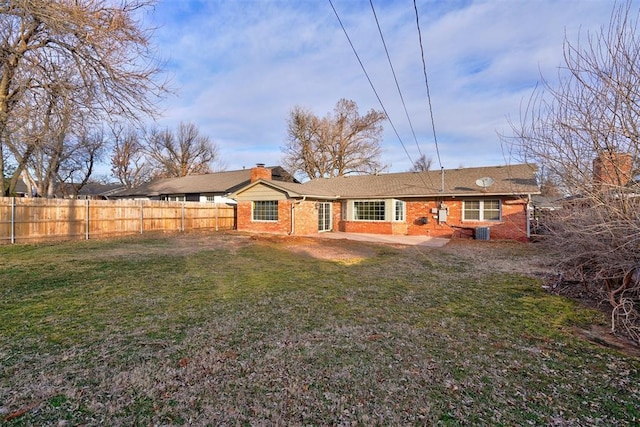 rear view of house with a yard, a patio area, and central air condition unit