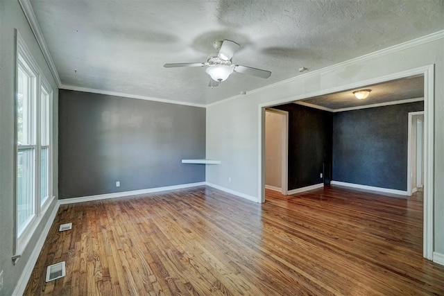 unfurnished room with crown molding, ceiling fan, hardwood / wood-style floors, and a textured ceiling