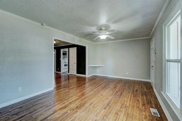 unfurnished room with hardwood / wood-style flooring, ornamental molding, a textured ceiling, and ceiling fan