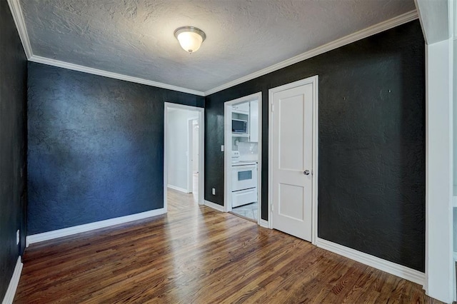 unfurnished bedroom featuring ornamental molding, dark wood-type flooring, and a textured ceiling