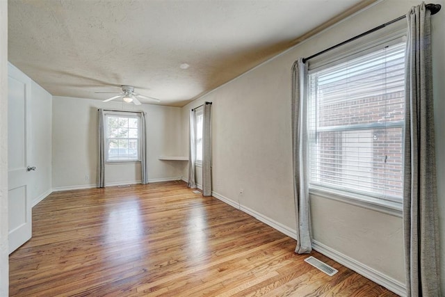 empty room with ceiling fan and light wood-type flooring