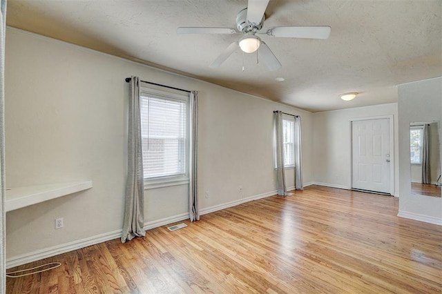 spare room with ceiling fan and light hardwood / wood-style flooring