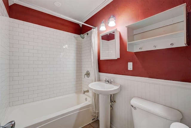 full bathroom with sink, shower / bath combo, toilet, crown molding, and tile patterned floors