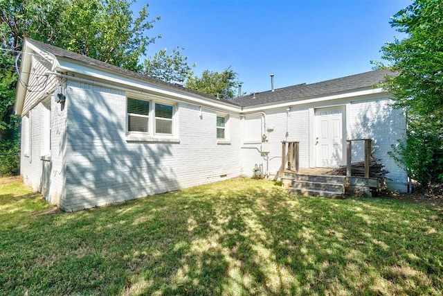 rear view of house with a lawn