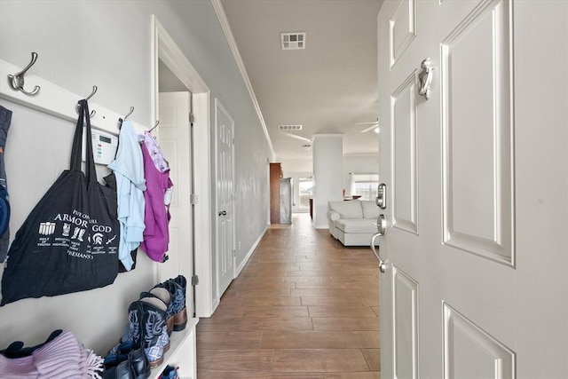 mudroom featuring hardwood / wood-style flooring and ornamental molding