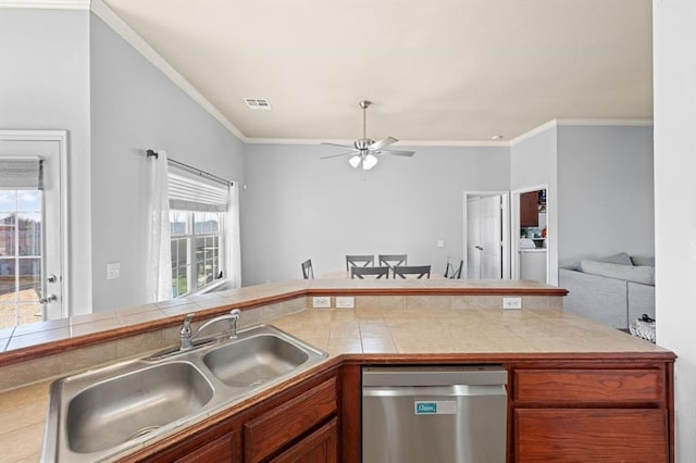 kitchen featuring sink, crown molding, tile counters, and stainless steel dishwasher