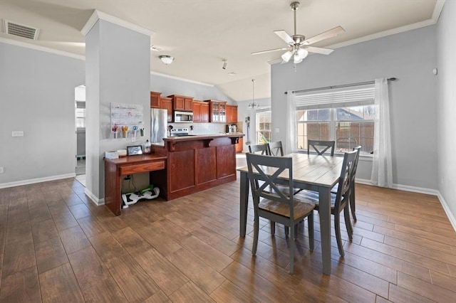 dining room with crown molding, ceiling fan, lofted ceiling, and dark hardwood / wood-style flooring