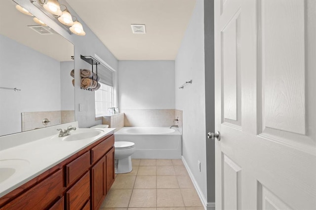 bathroom featuring vanity, tile patterned floors, toilet, and a bathing tub