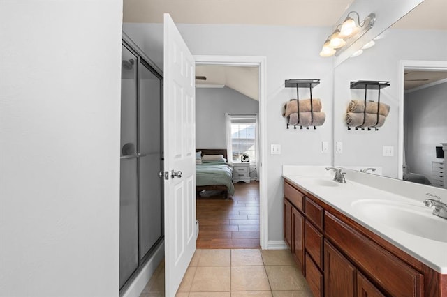 bathroom with tile patterned flooring, vanity, and an enclosed shower