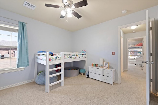 bedroom with light colored carpet and ceiling fan