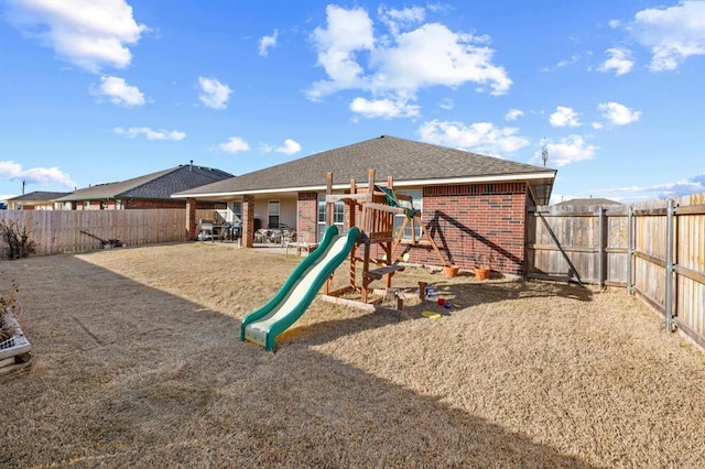 view of playground with a patio