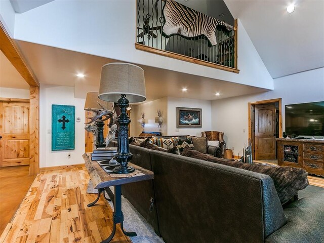 living room featuring a high ceiling and hardwood / wood-style floors