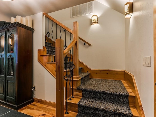 stairs featuring wood-type flooring