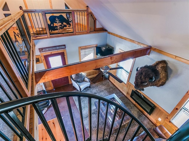 staircase featuring ceiling fan and vaulted ceiling