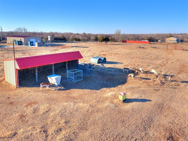 view of yard featuring an outdoor structure and a rural view