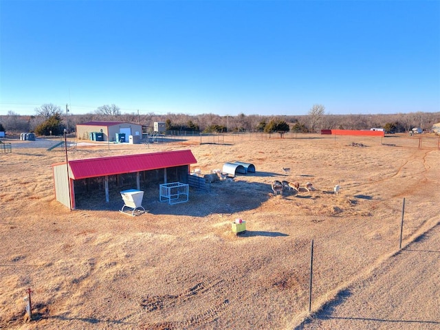 view of yard with a rural view and an outdoor structure