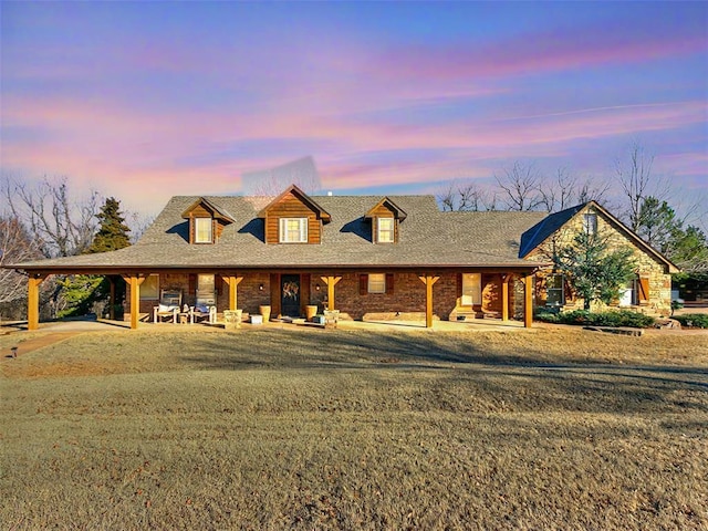 view of front of home featuring a yard and a patio