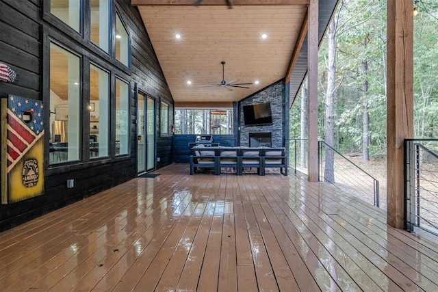 deck featuring a fireplace and ceiling fan