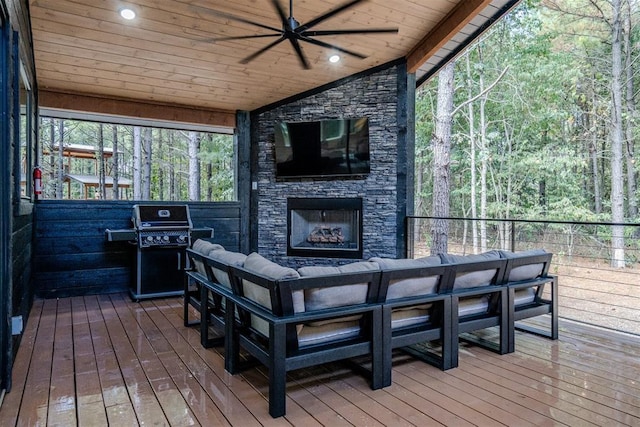 deck with ceiling fan, a grill, and an outdoor living space with a fireplace