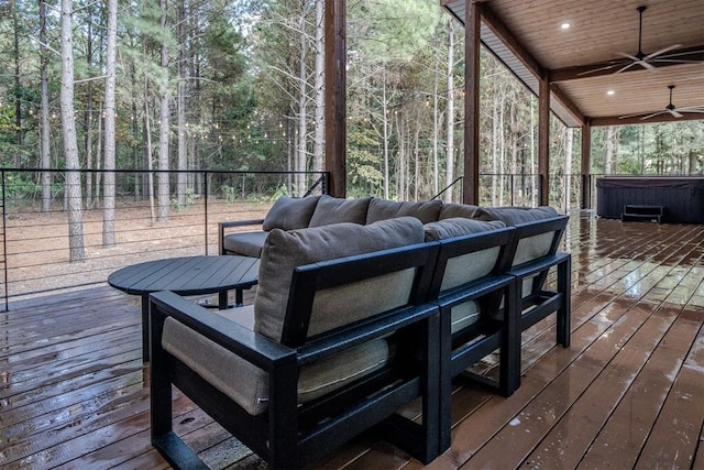 wooden deck featuring a hot tub and ceiling fan