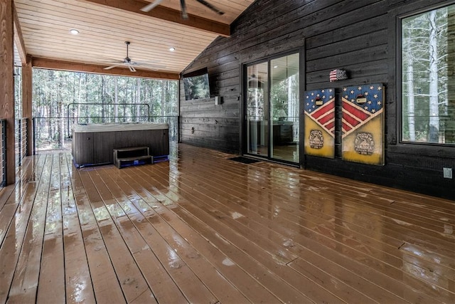 wooden deck with ceiling fan and a hot tub