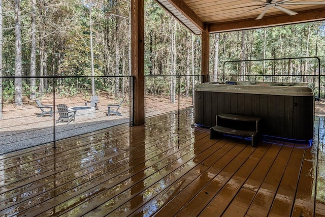 deck featuring ceiling fan and a hot tub