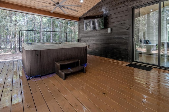 wooden terrace featuring ceiling fan and a hot tub