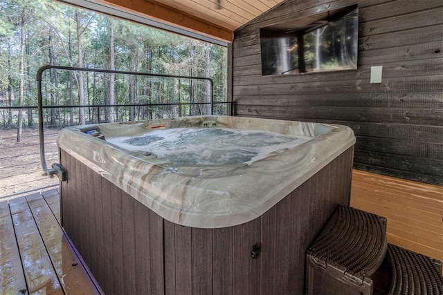 wooden deck featuring a hot tub