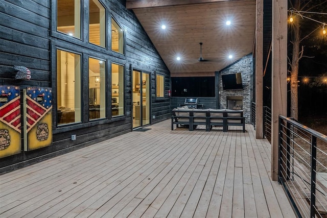 deck featuring an outdoor living space with a fireplace