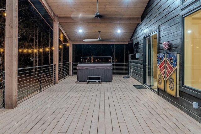 wooden deck featuring a hot tub and ceiling fan