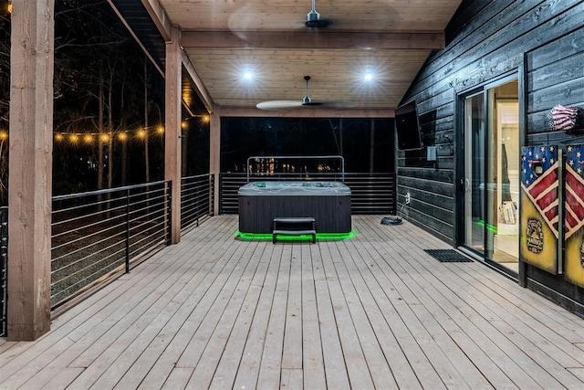 wooden deck with ceiling fan and a hot tub