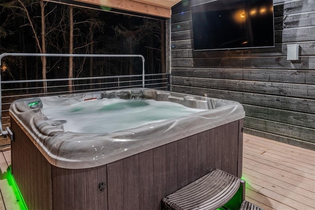 miscellaneous room featuring a hot tub and wood walls