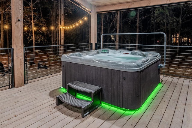 wooden deck featuring a hot tub